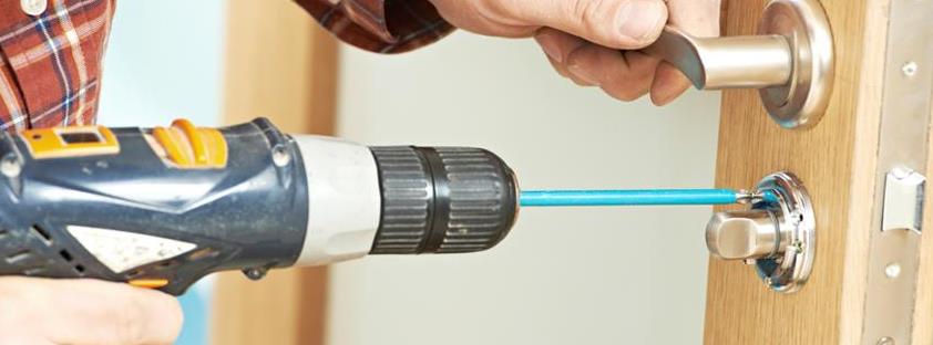 Man using drilling tools in the door