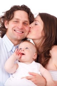 A Couple holding the baby
