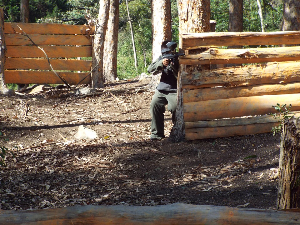 a person hiding in wooden wall